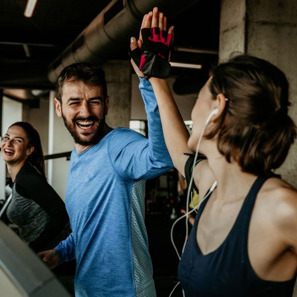 two people in the gym smiling and clapping