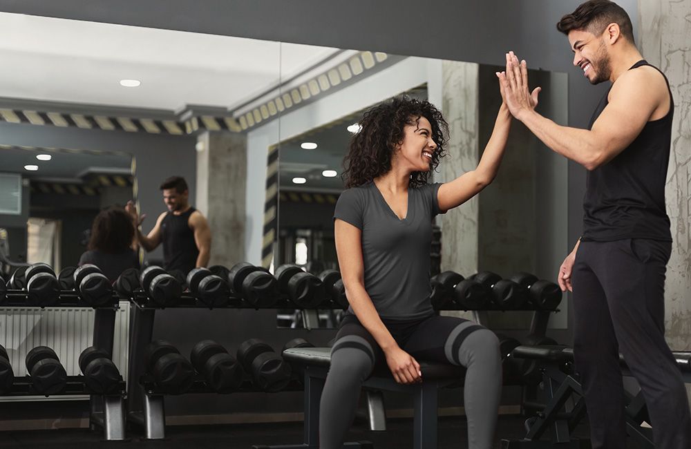 Personal trainer giving a client a high-five