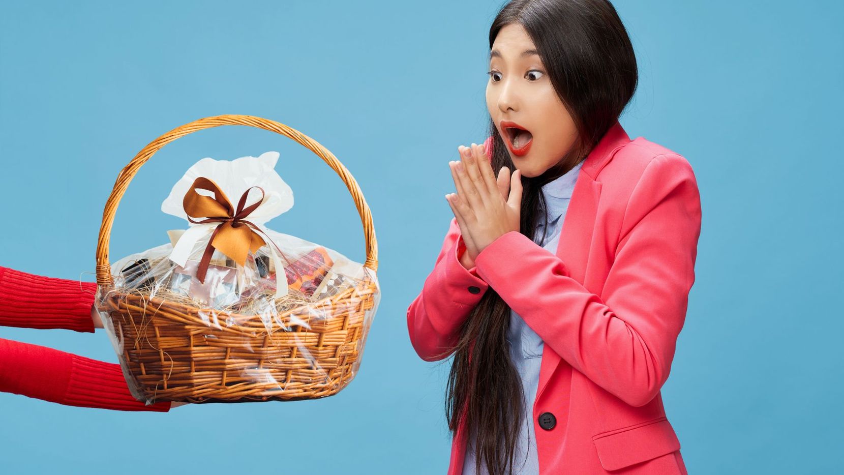 woman surprised receiving gift basket