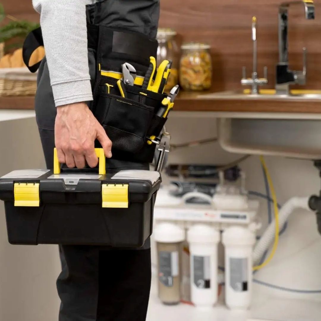 Plumber with a toolbox and belt