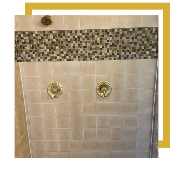 Shower wall tile accent border with freshly repaired grout