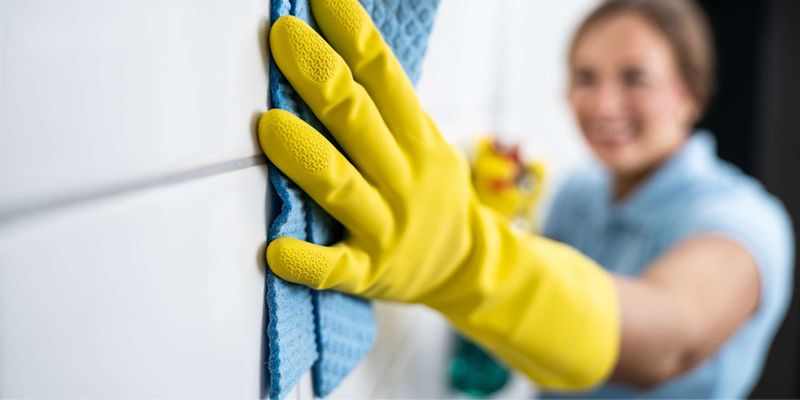 woman cleaning grout