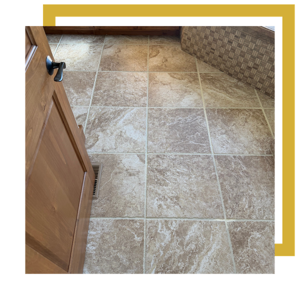 Beige stone tile floor after grout color sealing