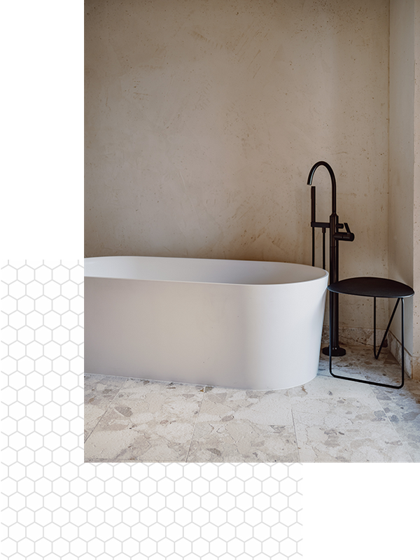 A modern tub  in a bathroom with tile floors