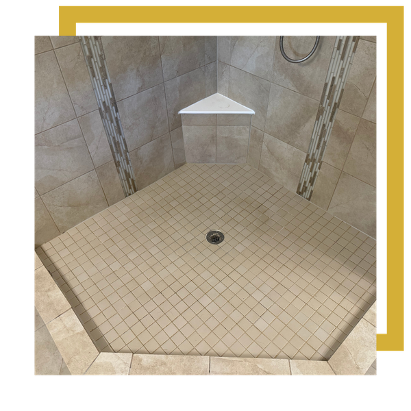 Repaired grout on mosaic shower floor with corner seat