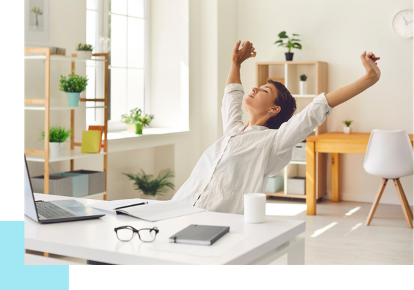 happy woman stretching at desk at home