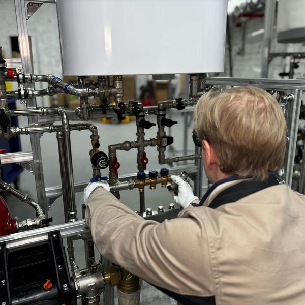 A plumber inspecting pipes