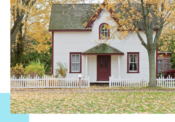 a nice white and red home with a white pciket fence