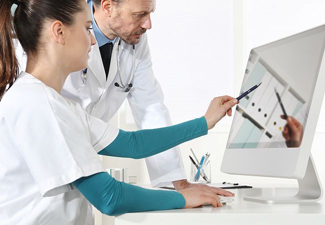 medical nurse pointing at computer