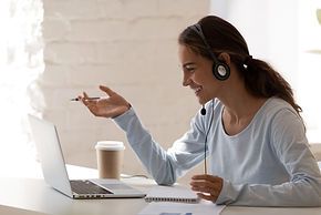 woman smiling on phone with computer