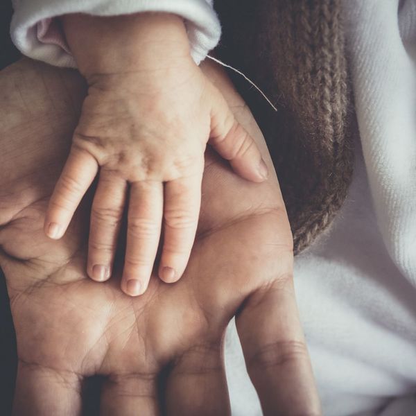 child hand in parent hand