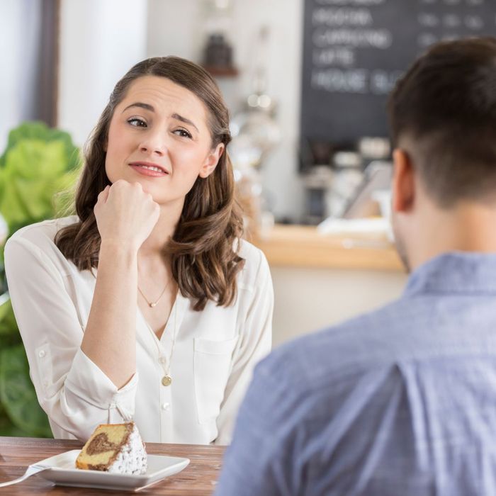 a woman looking untrustingly at her date across from her