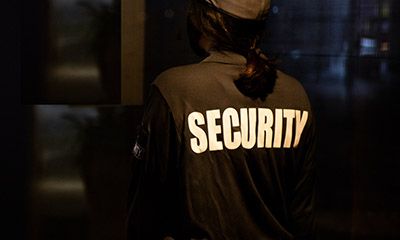 Image of a security guard making rounds at night.