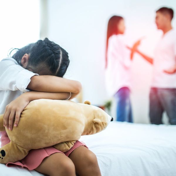 sad child with parents fighting