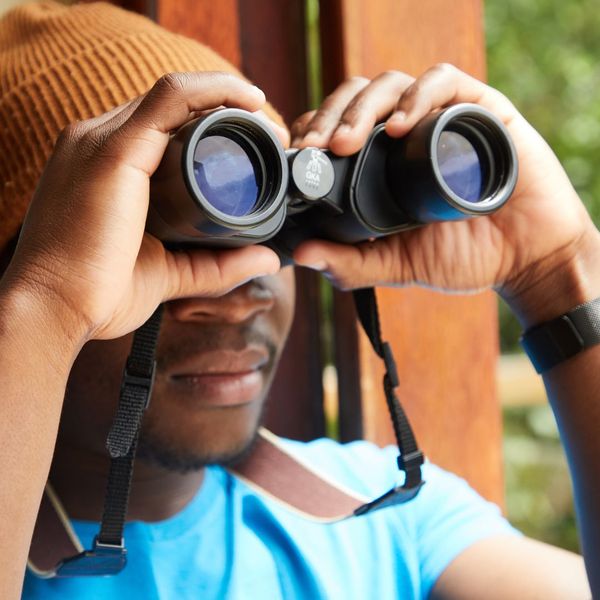 man looking through binoculars