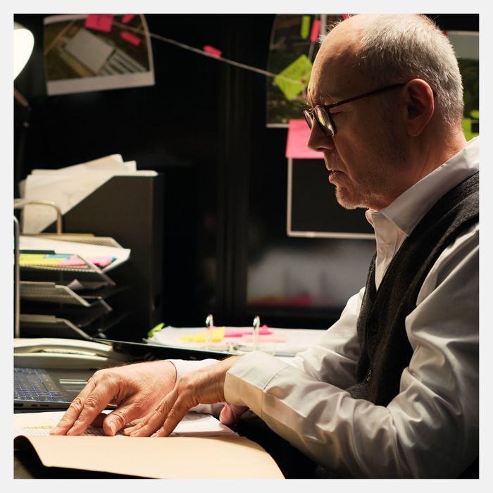 older man looking over case files