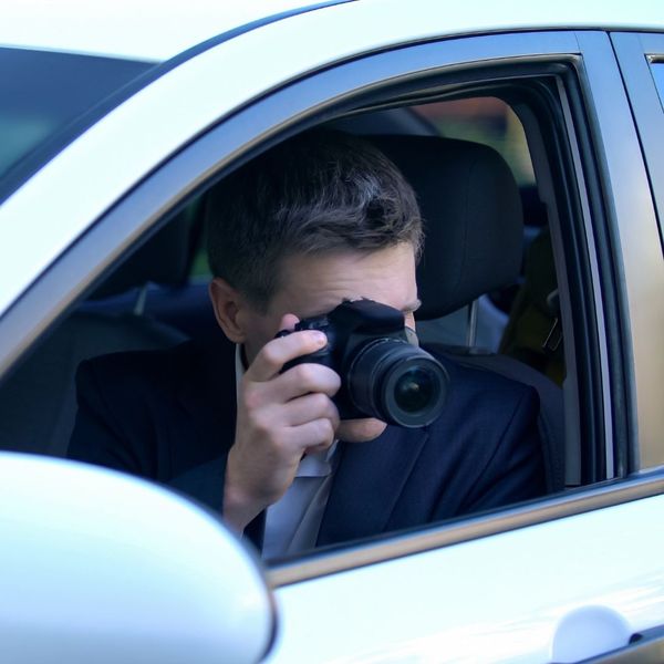 a person using a camera out a car window