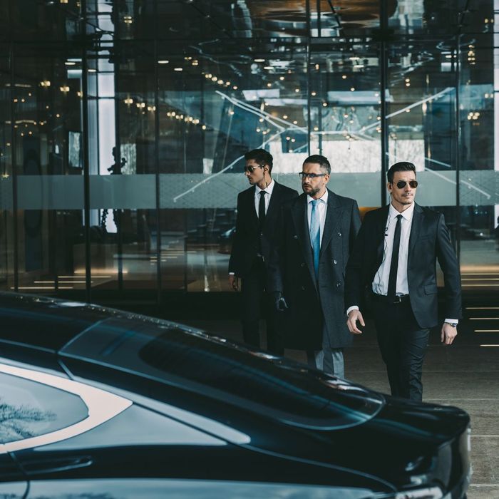 2 bodyguards escorting client to car