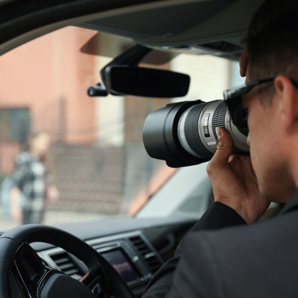 man in car taking photos