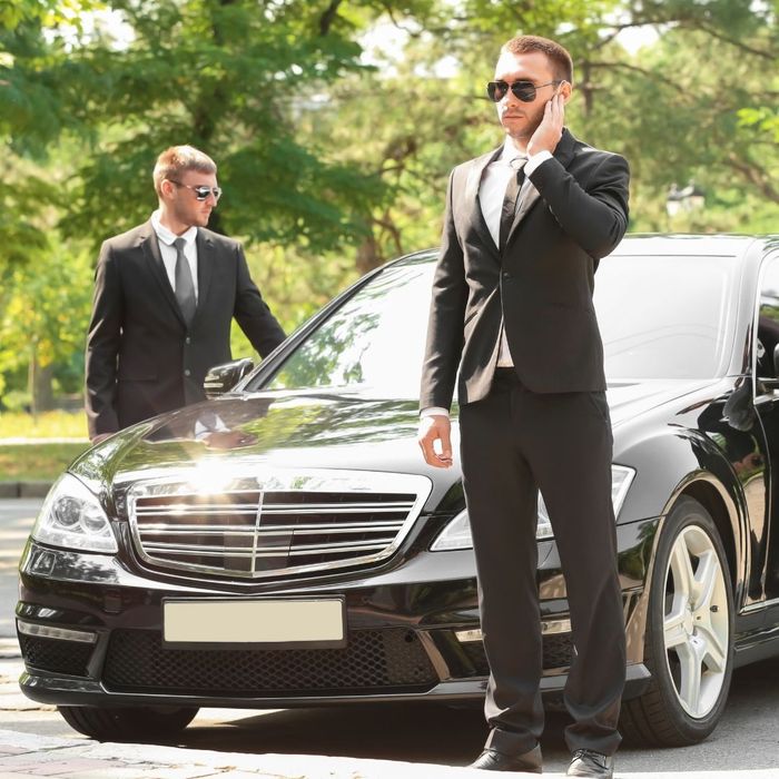 two bodyguards guarding client's car