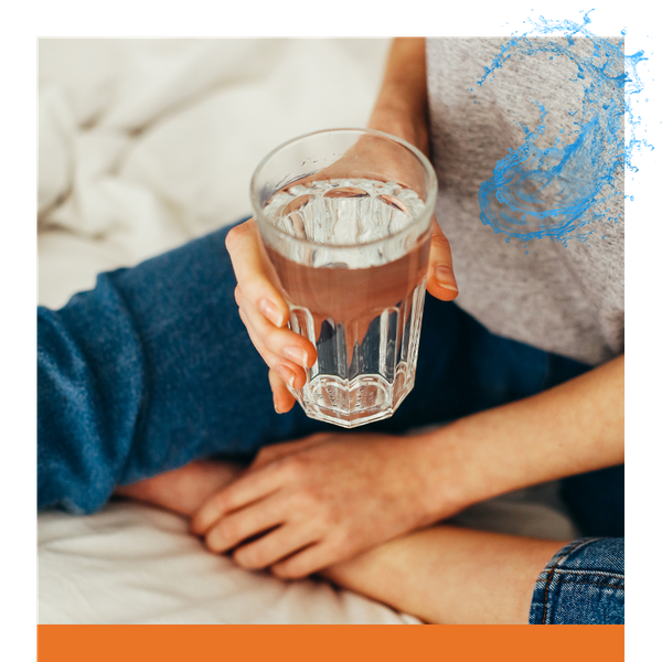 person holding a glass of water