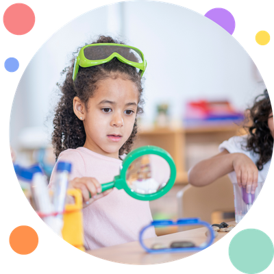 girl using magnifying glass 