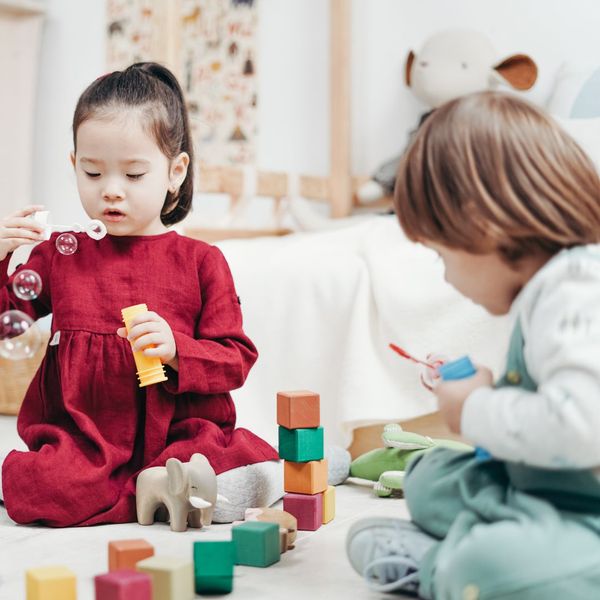 Toddlers playing with bubbles and blocks