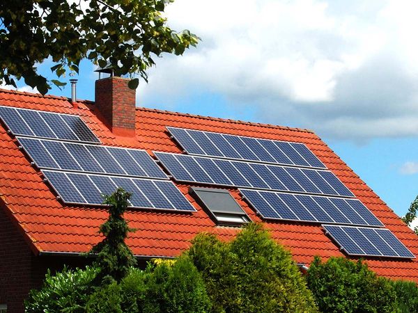 Solar panels on a residential roof for environmentally-friendly sustainable energy.