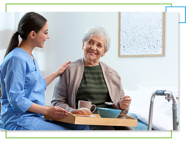 Woman helping elder eat at home