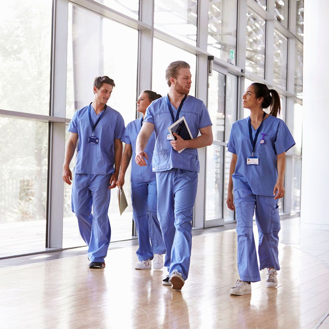 team of hospital workers walking through hall