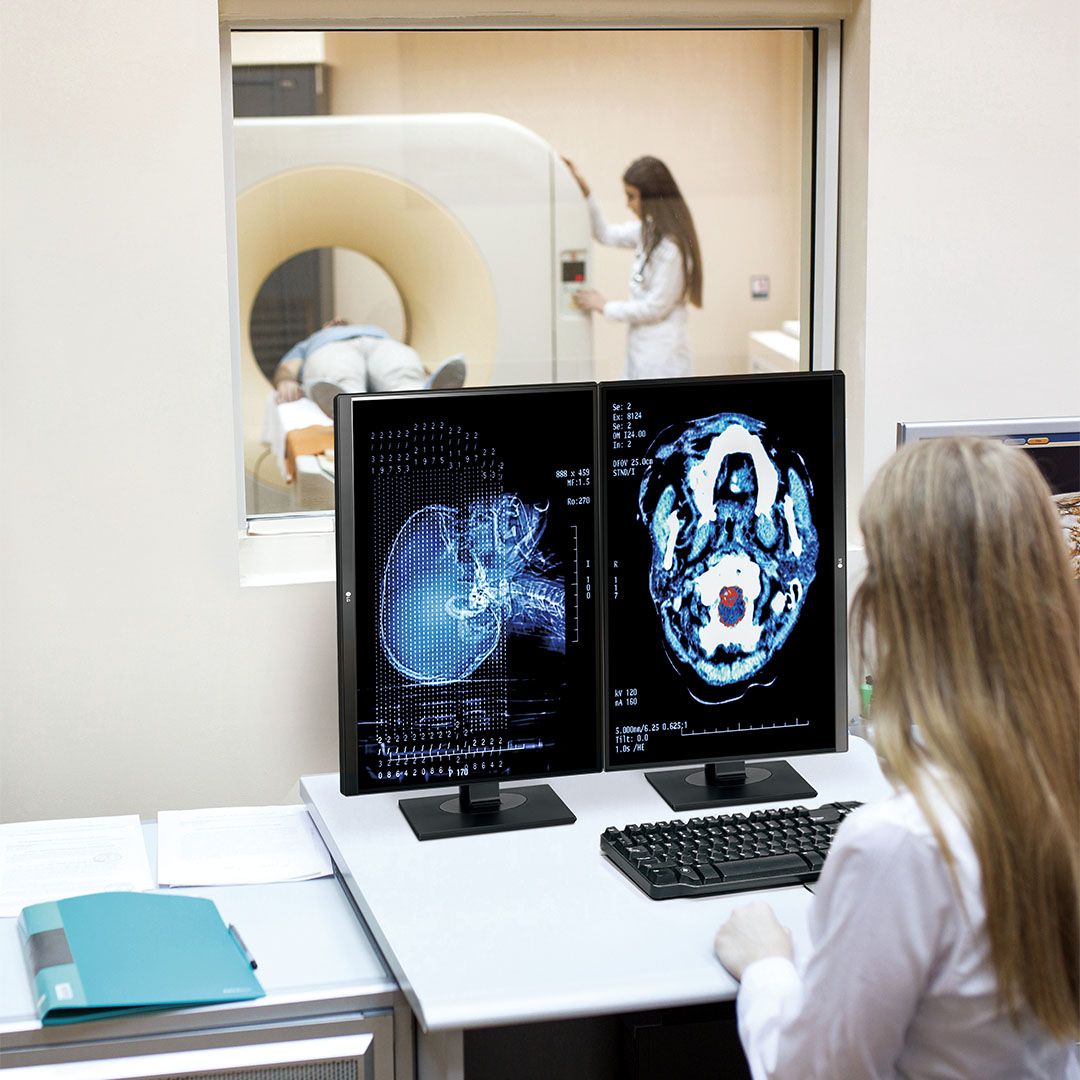 lab technician looking at MRI scan