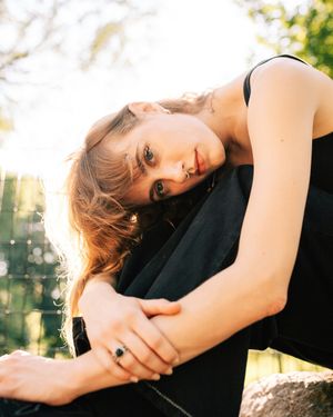 moody photo of woman sitting outside