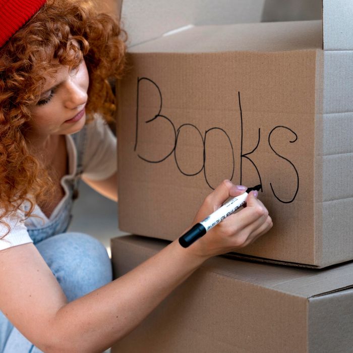 an image of a woman labeling a box