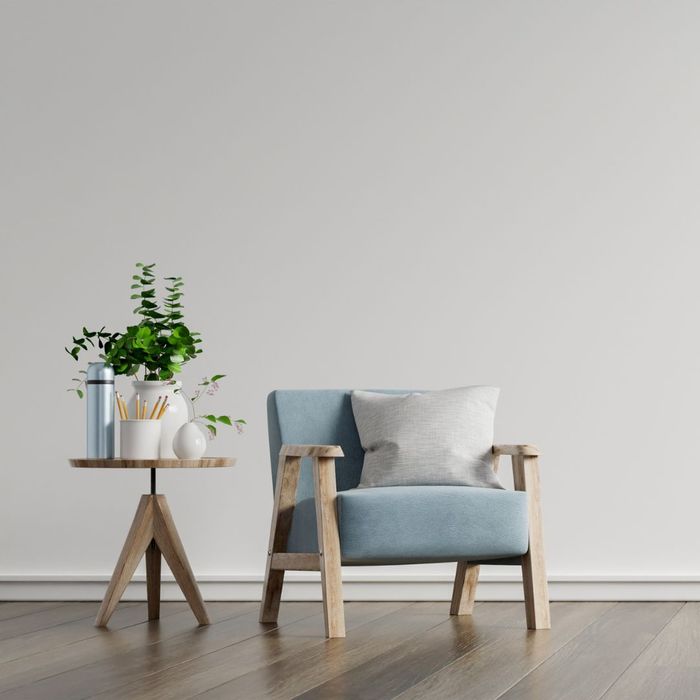 chair and table in front of white wall
