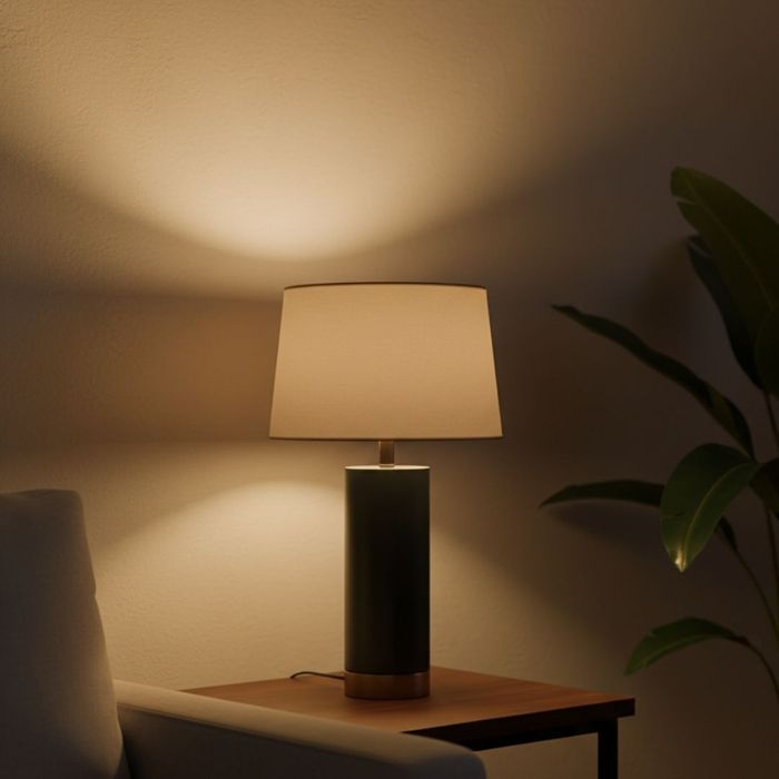 Stylish table lamp casting a warm, ambient glow in a dark room