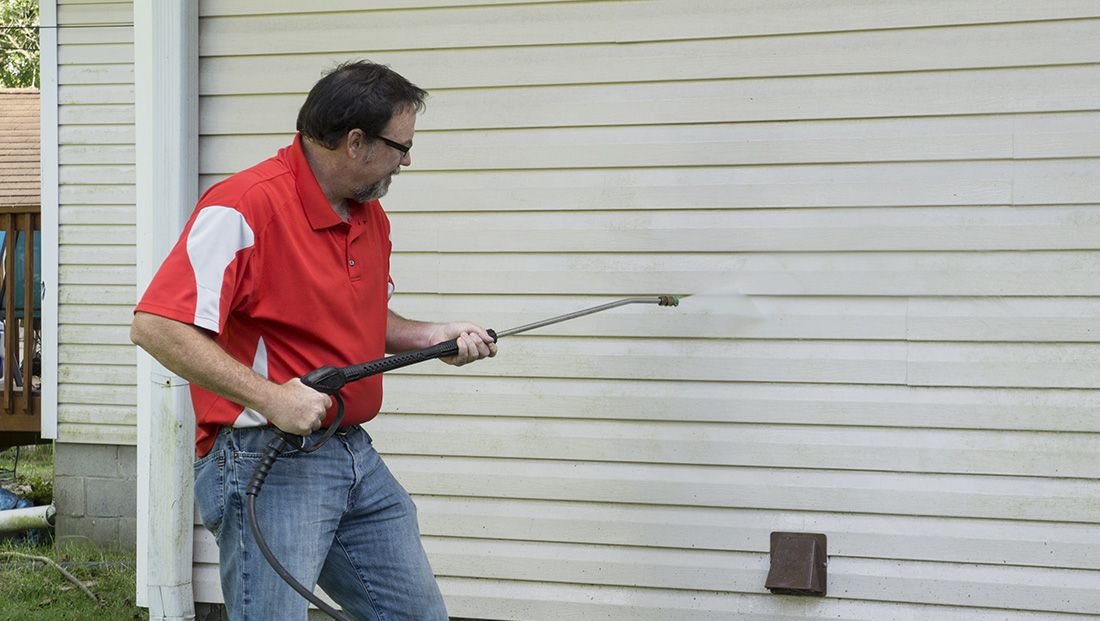 a professional power washing mold off of house siding