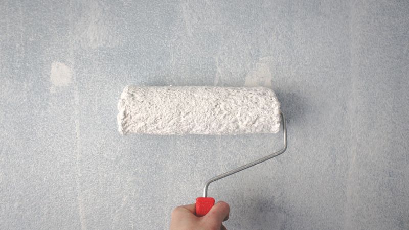 Paint roller on a wall