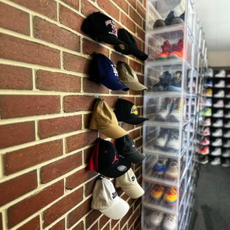 Fashion and streetwear baseball caps displayed front-facing using The Original Squatchee™ adhesive hat hooks. Fashion & Streetwear Baseball Cap Display