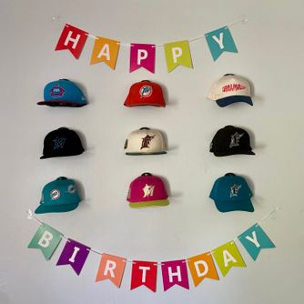 A real customer baseball cap collection displayed using The Original Squatchee™ adhesive hat hooks. Customer Hat Wall Display