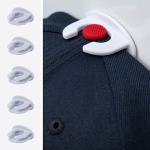 A detailed image of The Original Squatchee™ adhesive hat hook holding a hat, showcasing its unique patented design and secure fit for hat collections. Close-Up of Hat Hook in Use