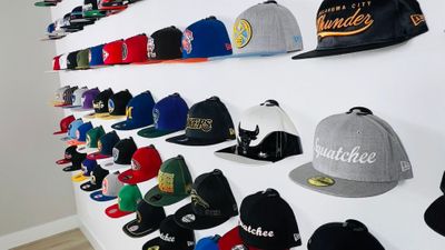 Hats displayed on a wall with Squatchee hat hangers
