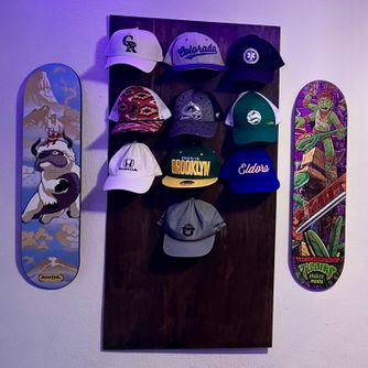 A real customer baseball cap collection displayed using The Original Squatchee™ adhesive hat hooks. Customer Hat Wall Display