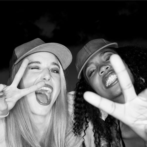 Two people wearing baseball caps representing the passion and personal style that inspire baseball cap collections. People Wearing Baseball Caps