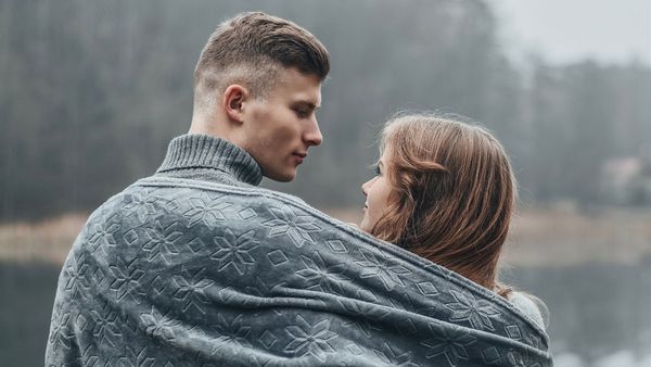 A couple in a blanket. M37406 - Save Big on Your Protection This Black Friday Hero Image.jpg