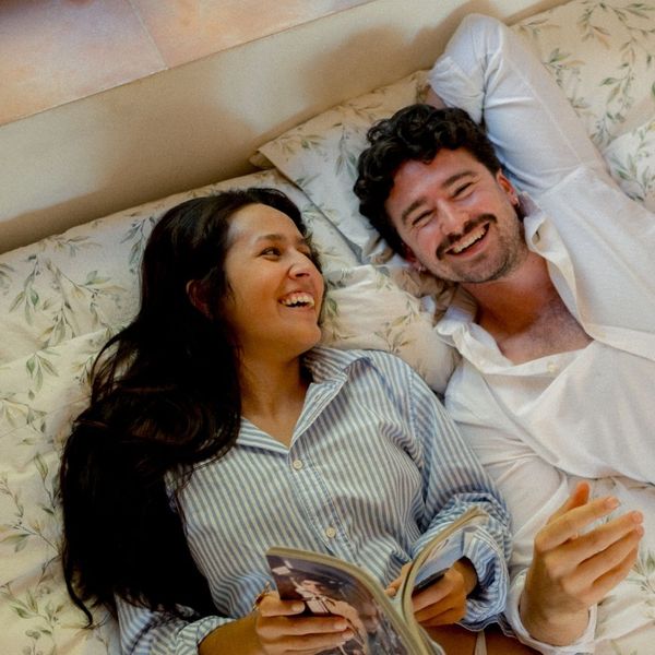 A couple laughing together in bed