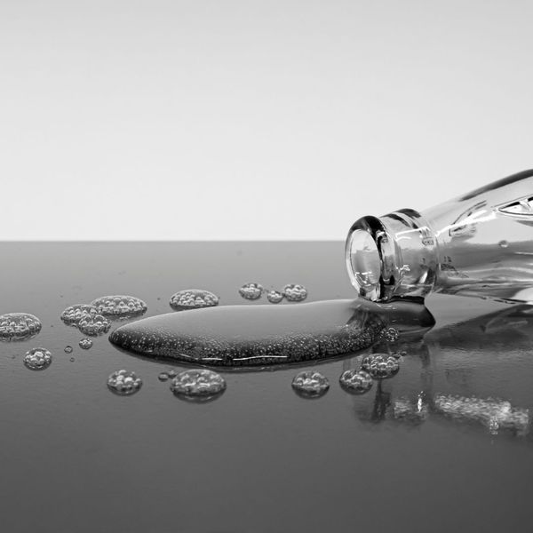 A glass spilling water onto a surface
