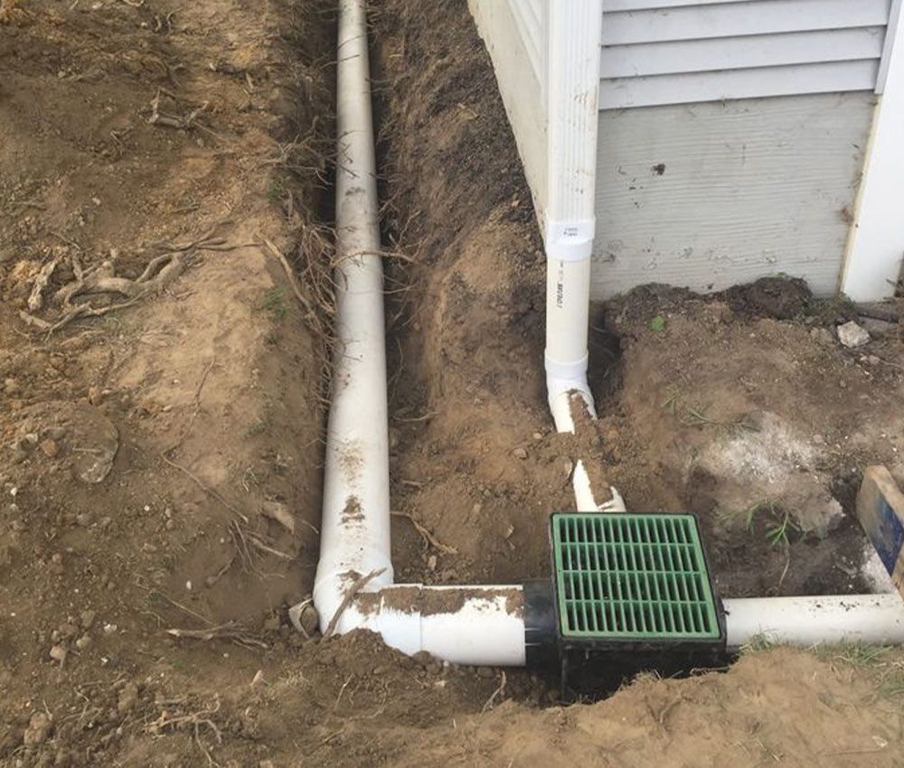 an exterior French drain with an above ground grate