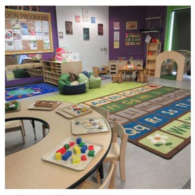 playroom for children with alphabet mat, bean bag chairs, wooden blocks for play