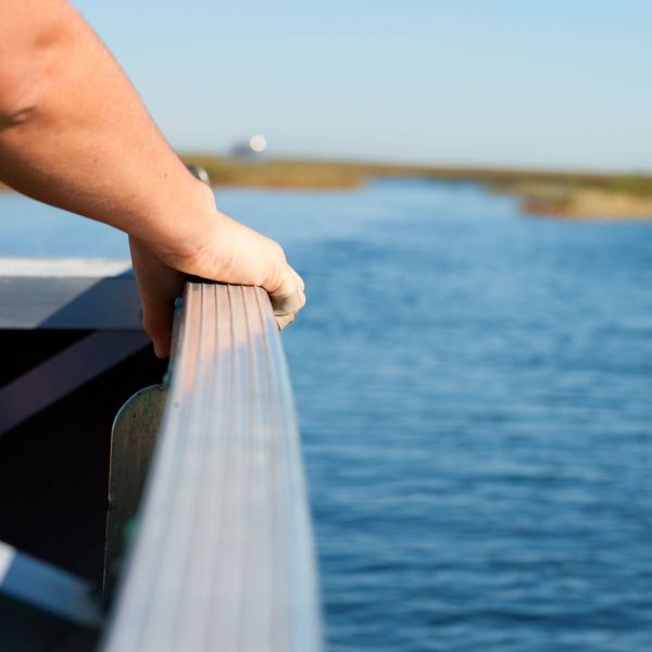 hand holding resting on side of boat