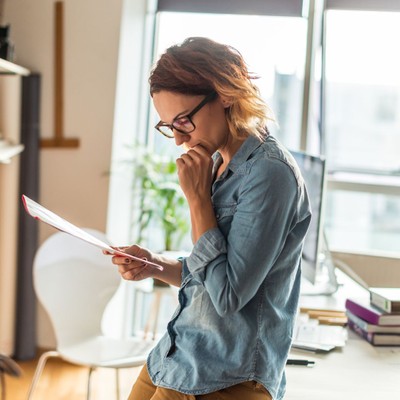 a woman reviewing paperwork in her apartment